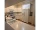 Bright kitchen featuring white cabinets, countertops, and appliances, including a refrigerator and microwave at 3790 Cadbury Cir # 40, Venice, FL 34293