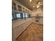 Well-lit kitchen featuring white cabinetry, a full suite of appliances, tile flooring, and plenty of prep space for cooking at 3790 Cadbury Cir # 40, Venice, FL 34293