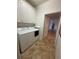 Convenient laundry room including washer, dryer and ample overhead storage at 3790 Cadbury Cir # 40, Venice, FL 34293