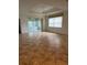 Spacious living room with tile floors, sliding glass doors to the lanai, and a ceiling fan, ideal for relaxing or entertaining at 3790 Cadbury Cir # 40, Venice, FL 34293