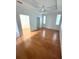 Spacious main bedroom with hardwood floors, a ceiling fan, two windows and a walk-in closet; comfort meets style at 3790 Cadbury Cir # 40, Venice, FL 34293