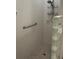 Walk-in shower with white tile, glass block accents, and grab bar, ensuring accessibility and style at 3790 Cadbury Cir # 40, Venice, FL 34293