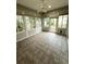 Relaxing sunroom with tile flooring and windows providing natural light and backyard views at 3790 Cadbury Cir # 40, Venice, FL 34293