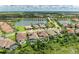 Aerial view of a home featuring a private pool, beautifully situated in a lakeside community at 4740 Royal Dornoch Cir, Bradenton, FL 34211