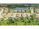 An aerial view of a home with a pool, nestled in a community with a tranquil lake at 4740 Royal Dornoch Cir, Bradenton, FL 34211