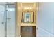 Well-lit bathroom with a glass-enclosed shower, modern vanity with storage, and a large mirror at 4740 Royal Dornoch Cir, Bradenton, FL 34211