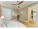 Bright bedroom featuring a ceiling fan, neutral walls, closet, and doorway leading to another room at 4740 Royal Dornoch Cir, Bradenton, FL 34211