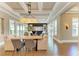 Open-concept living space boasts coffered ceilings, seamless flow between the dining and living areas, and access to the outdoors at 4740 Royal Dornoch Cir, Bradenton, FL 34211