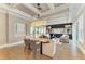 Elegant dining room with coffered ceilings, stylish lighting, and views of the outdoor living area at 4740 Royal Dornoch Cir, Bradenton, FL 34211