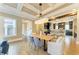 Elegant dining area with wood table, coffered ceiling, and modern lighting fixture at 4740 Royal Dornoch Cir, Bradenton, FL 34211