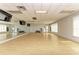 An airy fitness room has ample space for activities like yoga, dance, and group exercise, complete with mirrors at 4740 Royal Dornoch Cir, Bradenton, FL 34211