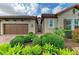 Charming home featuring manicured landscaping, a brick driveway, and an attached two-car garage at 4740 Royal Dornoch Cir, Bradenton, FL 34211