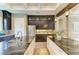 Dual islands with granite countertops, dark wood cabinetry, and stainless steel refrigerator at 4740 Royal Dornoch Cir, Bradenton, FL 34211