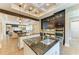 Contemporary kitchen with granite countertops, stainless steel appliances, and an island with sink at 4740 Royal Dornoch Cir, Bradenton, FL 34211