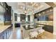 Gourmet kitchen boasts dark cabinets, granite counters, island seating, and stainless steel appliances at 4740 Royal Dornoch Cir, Bradenton, FL 34211
