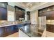 Modern kitchen features granite counters, stainless steel appliances, dark cabinets, and island sink at 4740 Royal Dornoch Cir, Bradenton, FL 34211