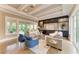 Bright living room features coffered ceilings, built-in storage, and sliding glass doors to the outdoor area at 4740 Royal Dornoch Cir, Bradenton, FL 34211