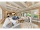 Open-concept space with coffered ceilings, living area, dining space, and seamless flow to the outdoor living areas at 4740 Royal Dornoch Cir, Bradenton, FL 34211