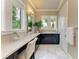 Main bathroom features marble floors, white quartz countertops and ample counter space at 4740 Royal Dornoch Cir, Bradenton, FL 34211