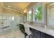 Main bathroom features marble floors, white quartz countertops and glass enclosed shower at 4740 Royal Dornoch Cir, Bradenton, FL 34211