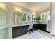 Main bathroom features marble floors, dual vanity and large windows with a green view at 4740 Royal Dornoch Cir, Bradenton, FL 34211