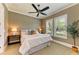 Comfortable bedroom with two windows and plush carpet featuring a decorative ceiling fan and neutral walls at 4740 Royal Dornoch Cir, Bradenton, FL 34211