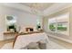 Bright main bedroom features tray ceiling and view of landscaped yard at 4740 Royal Dornoch Cir, Bradenton, FL 34211