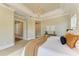 Relaxing primary suite with paneled walls, a chandelier, and access to the primary bathroom at 4740 Royal Dornoch Cir, Bradenton, FL 34211