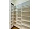 Walk-in pantry with custom built-in white shelving offers ample storage space at 4740 Royal Dornoch Cir, Bradenton, FL 34211