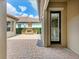 Charming brick patio with an outdoor fireplace, perfect for entertaining and enjoying the backyard view at 4740 Royal Dornoch Cir, Bradenton, FL 34211