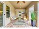 Cozy covered patio featuring comfortable seating, ceiling fan, and stylish decor, perfect for enjoying the outdoors year-round at 4740 Royal Dornoch Cir, Bradenton, FL 34211