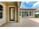 Outdoor patio area featuring a paver patio and glass sliding doors at 4740 Royal Dornoch Cir, Bradenton, FL 34211