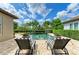 Backyard patio with lounge chairs by the pool, perfect for relaxing and enjoying the Florida sunshine at 4740 Royal Dornoch Cir, Bradenton, FL 34211