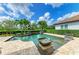 Inviting pool features decorative water features, surrounded by lush greenery, creating a tranquil and private outdoor retreat at 4740 Royal Dornoch Cir, Bradenton, FL 34211