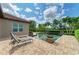 Backyard pool and brick patio with water feature, lounge chairs, tropical trees, and landscaping at 4740 Royal Dornoch Cir, Bradenton, FL 34211