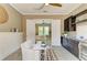 Stylish sitting area featuring a view into the main bedroom and adjacent cabinetry at 4740 Royal Dornoch Cir, Bradenton, FL 34211