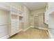 Bright, walk-in closet with custom shelving and multiple racks at 4740 Royal Dornoch Cir, Bradenton, FL 34211