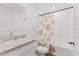 Well-lit bathroom with a vanity, toilet, and shower featuring a colorful shower curtain at 4890 Laramie Cir, North Port, FL 34286