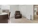 Bedroom with a recliner, side table, closet, and natural light from the window at 4890 Laramie Cir, North Port, FL 34286