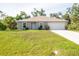 Well-maintained single-story home featuring a two-car garage, fresh landscaping, and a bright, inviting facade at 4890 Laramie Cir, North Port, FL 34286