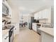Modern kitchen with white cabinets, stainless steel appliances, and an open view to the dining area at 4890 Laramie Cir, North Port, FL 34286