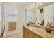 Well-lit bathroom with white-shuttered window and granite vanity at 5018 Bella Terra Dr, Venice, FL 34293
