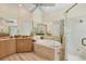 Bathroom featuring soaking tub, glass enclosed shower, and vanity area at 5018 Bella Terra Dr, Venice, FL 34293