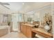 Bathroom with glass enclosed shower, soaking tub, and make up vanity at 5018 Bella Terra Dr, Venice, FL 34293