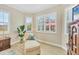 Bedroom with a chaise lounge, plantation shutters, and view to the lanai at 5018 Bella Terra Dr, Venice, FL 34293