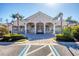 Exterior of the community clubhouse featuring classic architecture and well-manicured grounds at 5018 Bella Terra Dr, Venice, FL 34293