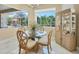 Bright dining room features a glass table set, view to the lanai, and built in hutch at 5018 Bella Terra Dr, Venice, FL 34293