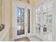 Elegant entryway with decorative glass doors and marble floors provides a grand entrance to the home at 5018 Bella Terra Dr, Venice, FL 34293