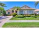 Well-manicured lawn and lush landscaping enhance this home's curb appeal, offering a welcoming view at 5018 Bella Terra Dr, Venice, FL 34293