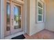 Close up of the beautiful front door with ornate glass accents and exterior shutters at 5018 Bella Terra Dr, Venice, FL 34293